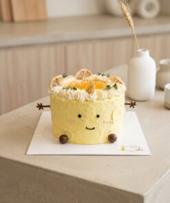 Yellow lemon-yuzu Jellycat-inspired chiffon cake with a smiling face, chocolate arms and citrus cream crown by iCake Melbourne