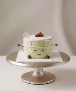 Matcha and strawberry Jellycat-inspired chiffon cake with soft green cream, a pink top and a sugar-dusted strawberry by iCake Melbourne