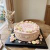 Soft pink Spring Garden Floral Birthday Cake with pastel piped roses, green vines and birthday lettering by iCake Melbourne