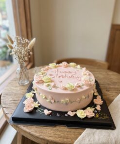 Soft pink Spring Garden Floral Birthday Cake with pastel piped roses, green vines and birthday lettering by iCake Melbourne