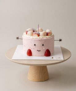 Pink strawberry Jellycat-inspired chiffon cake with a smiling face, chocolate arms and strawberry feet by iCake Melbourne
